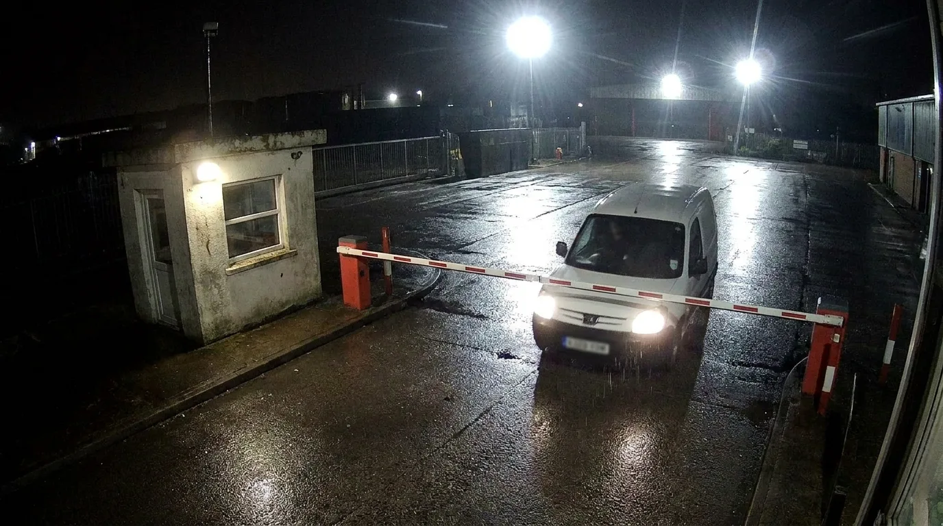 Gate camera framing a vehicle at a barrier for number plate reading